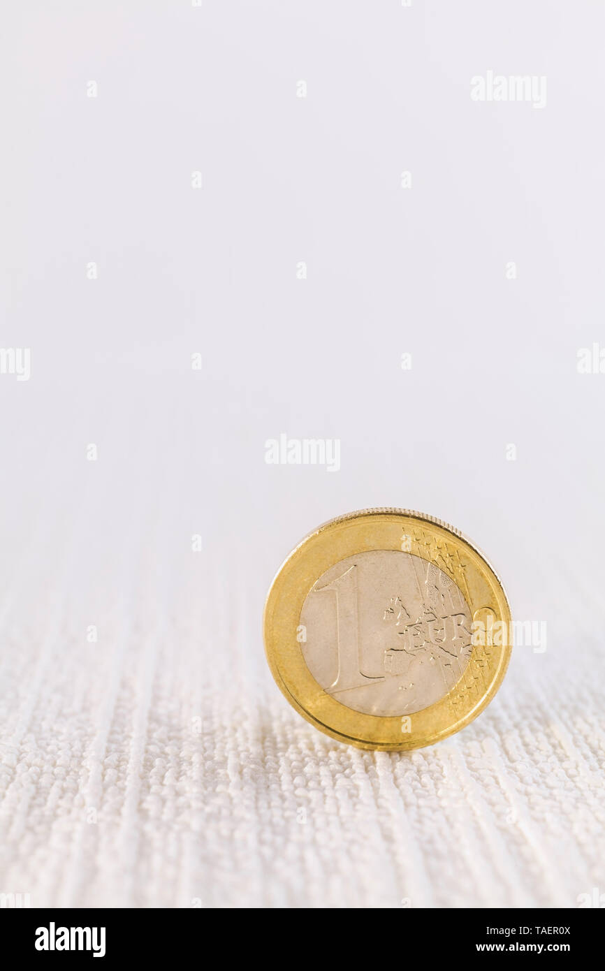 Upright one Euro coin on textured white background, Studio Composition, Quebec, Canada Stock Photo