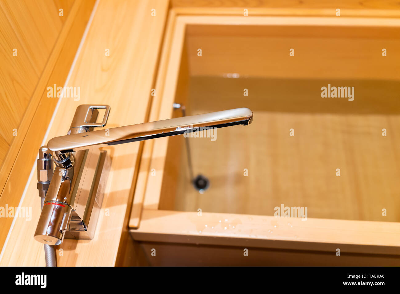 Clean cypress bathtub wooden traditional Japanese tub with water in home house or onsen hotel bathroom interior with nobody and in Japan Stock Photo