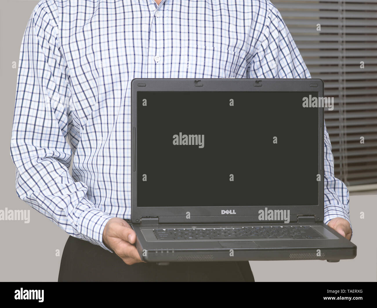 CORPORATE EXECUTIVE HOLDING A LAPTOP Stock Photo - Alamy