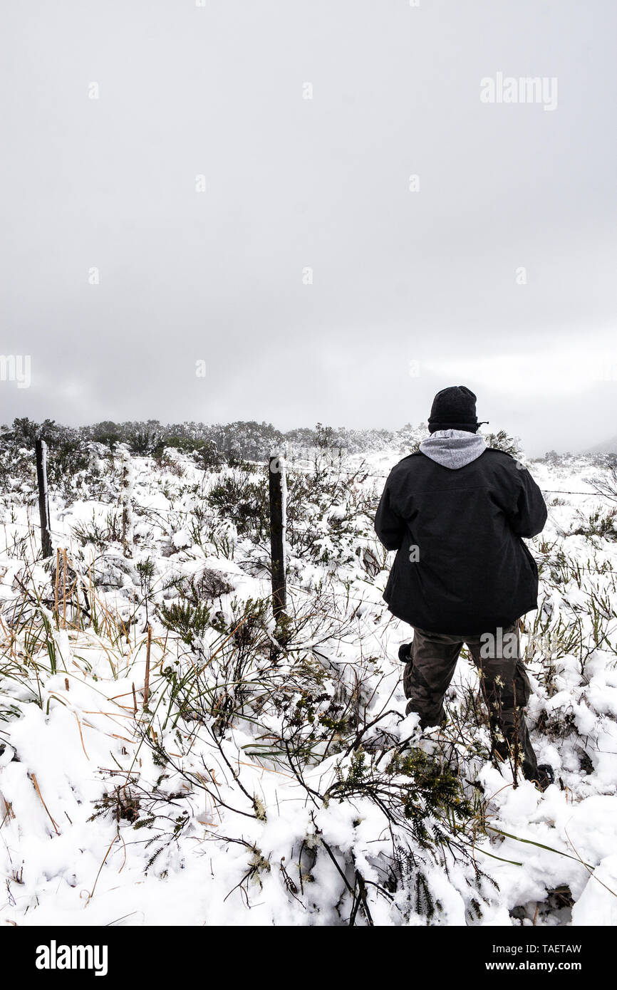 Man standing on a snowy ground.  Urubici, Santa Catarina, Brazil. Stock Photo
