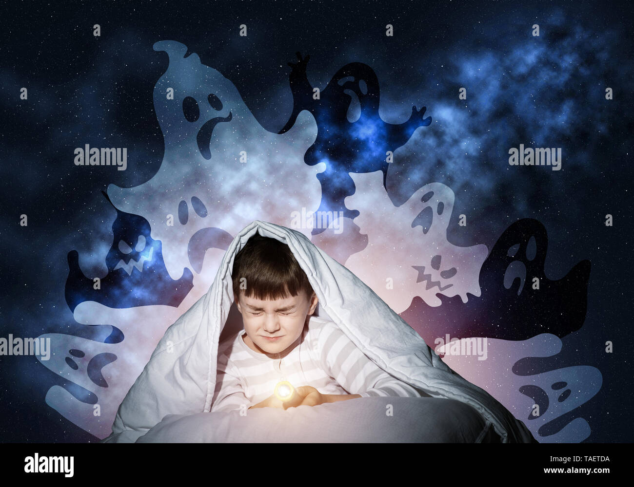 Scared boy hiding under blanket Stock Photo Alamy