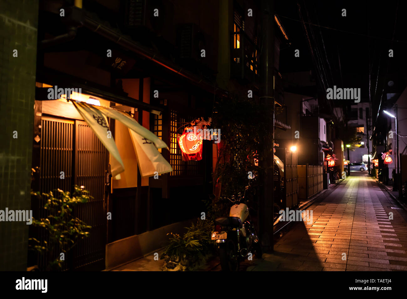 Kyoto, Japan - April 9, 2019: Narrow alley colorful empty street in Gion  district at night with red lantern and wind blowing curtains Stock Photo -  Alamy