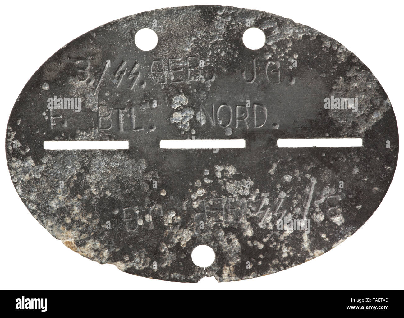 An identification tag, 6th SS Mountain Division 'Nord' Feinzink (migriert) mit vs. Bezeichnung '3./SS. Geb. Jg. F. Btl. Nord', rs. mit Markung '1288'. historic, historical, 20th century, 1930s, 1940s, Waffen-SS, armed division of the SS, armed service, armed services, NS, National Socialism, Nazism, Third Reich, German Reich, Germany, military, militaria, utensil, piece of equipment, utensils, object, objects, stills, clipping, clippings, cut out, cut-out, cut-outs, fascism, fascistic, National Socialist, Nazi, Nazi period, Editorial-Use-Only Stock Photo