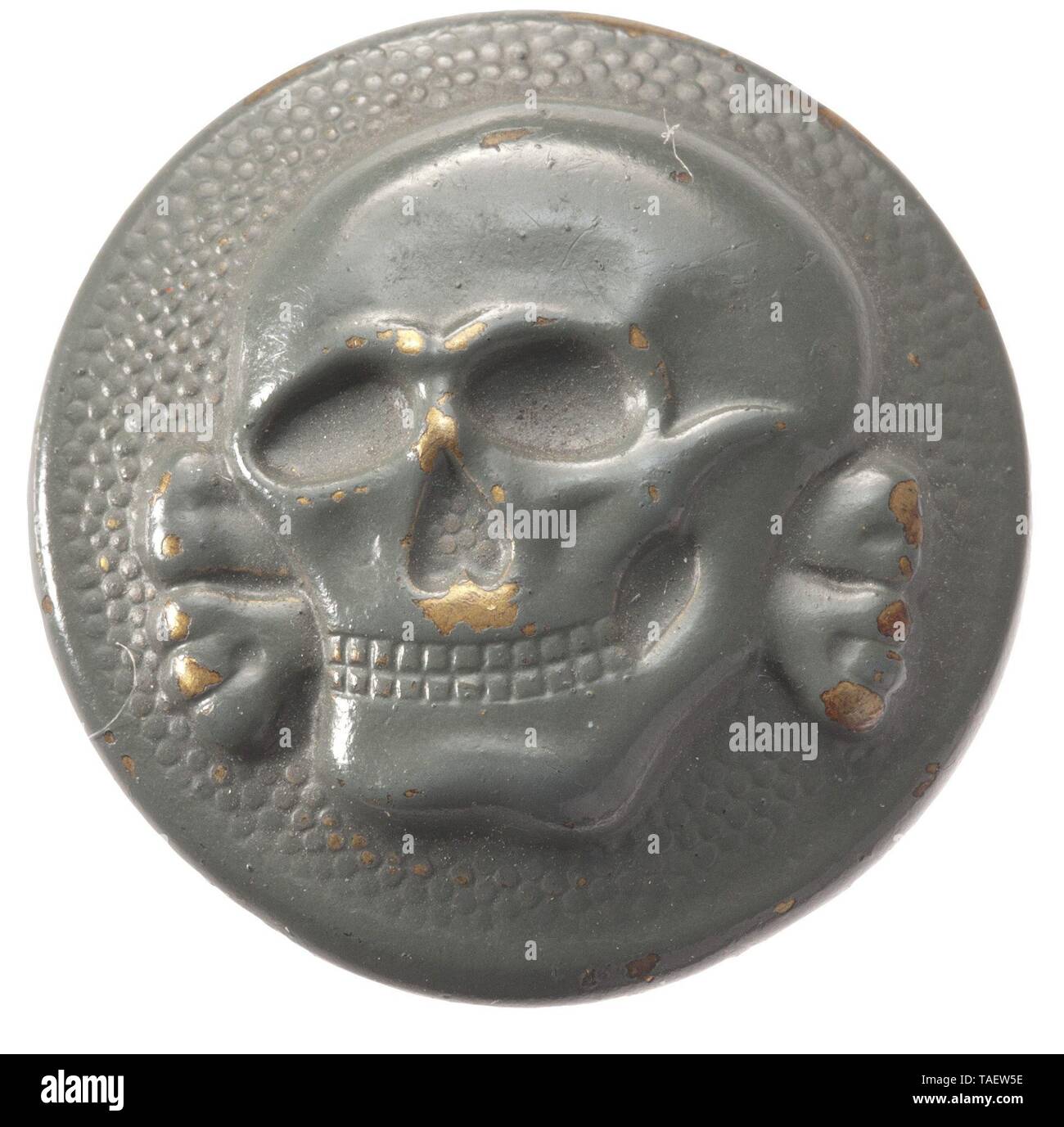 An SS cap button with death's head for the field cap Buntmetall, feldgrau lackiert (berieben). Reliefierter Totenkopf auf gekörntem Grund. Rs. der Herstellerstempel 'RZM M5/8'. Trage- und Altersspuren. Durchmesser 20 mm. historic, historical, 20th century, 1930s, 1940s, Waffen-SS, armed division of the SS, armed service, armed services, NS, National Socialism, Nazism, Third Reich, German Reich, Germany, military, militaria, utensil, piece of equipment, utensils, object, objects, stills, clipping, clippings, cut out, cut-out, cut-outs, fascism, fascistic, National Socialist,, Editorial-Use-Only Stock Photo