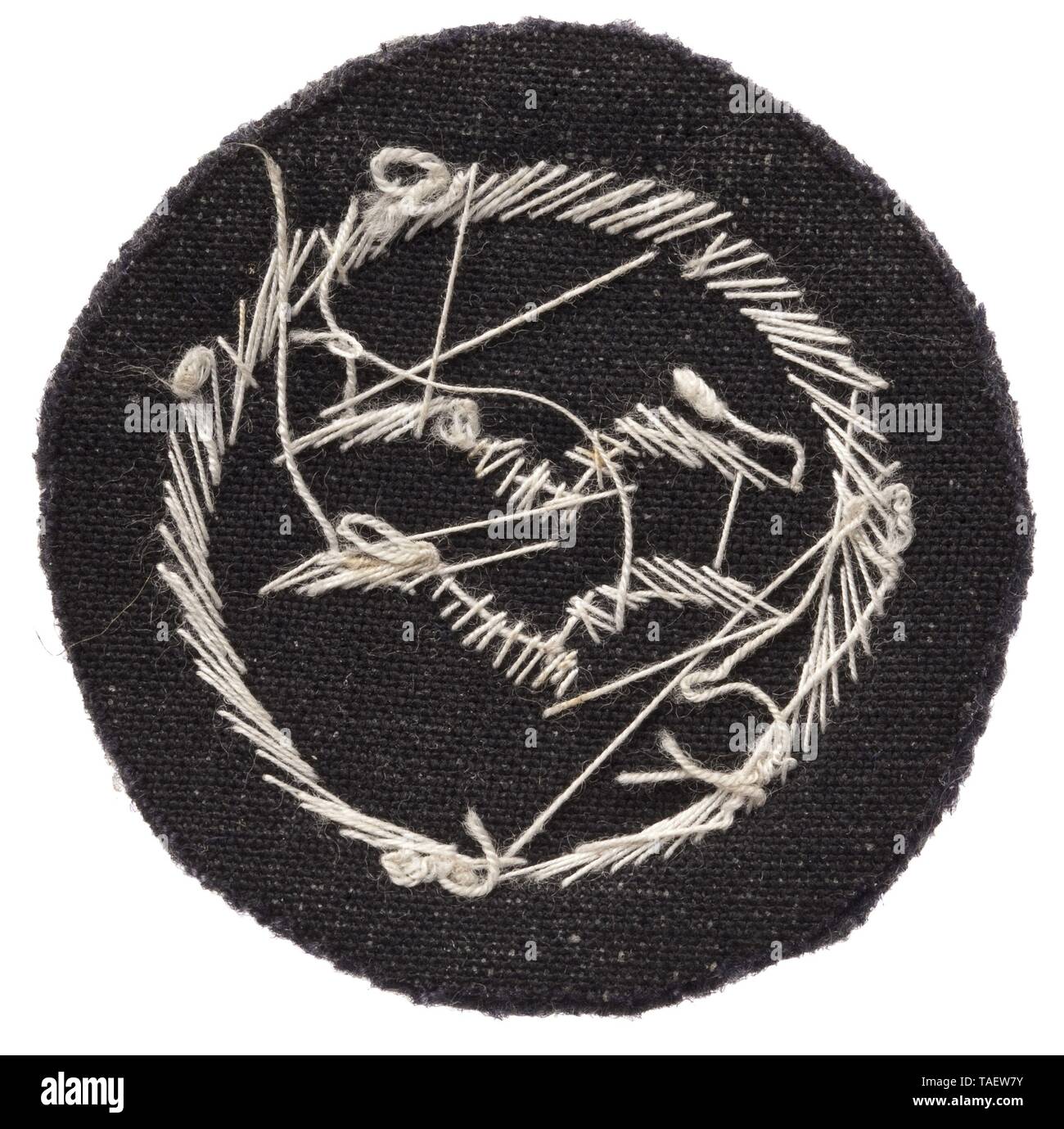 A glider pilot's badge 'B' certificate in officer quality cloth issue Zwei silberne, handgestickte Schwingen im Kranz auf grauem Wollfilz-Grund. Leichte Trage- und Altersspuren. Durchmesser 40 mm. historic, historical, Air Force, branch of service, branches of service, armed service, armed services, military, militaria, air forces, object, objects, stills, clipping, clippings, cut out, cut-out, cut-outs, 20th century, Editorial-Use-Only Stock Photo