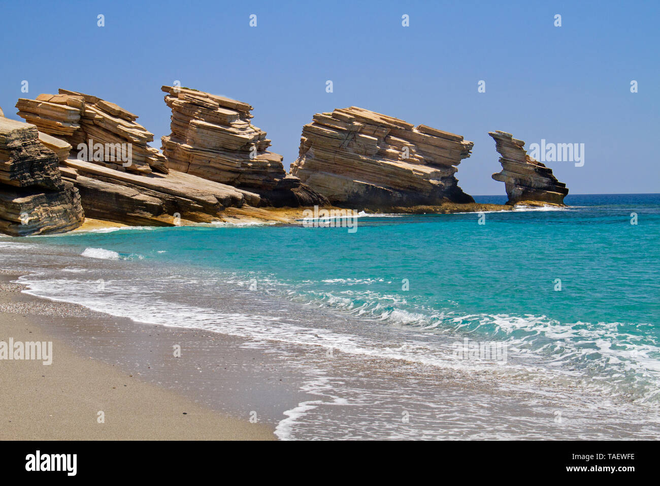 Triopetra, cliffs of platy sandstone on Crete in a turquoise sea Stock Photo