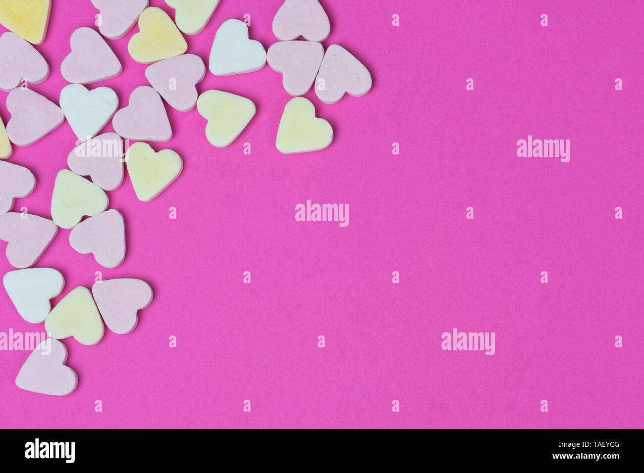 Pastel Colored Candy Hearts On Pink Background With Copy Space For