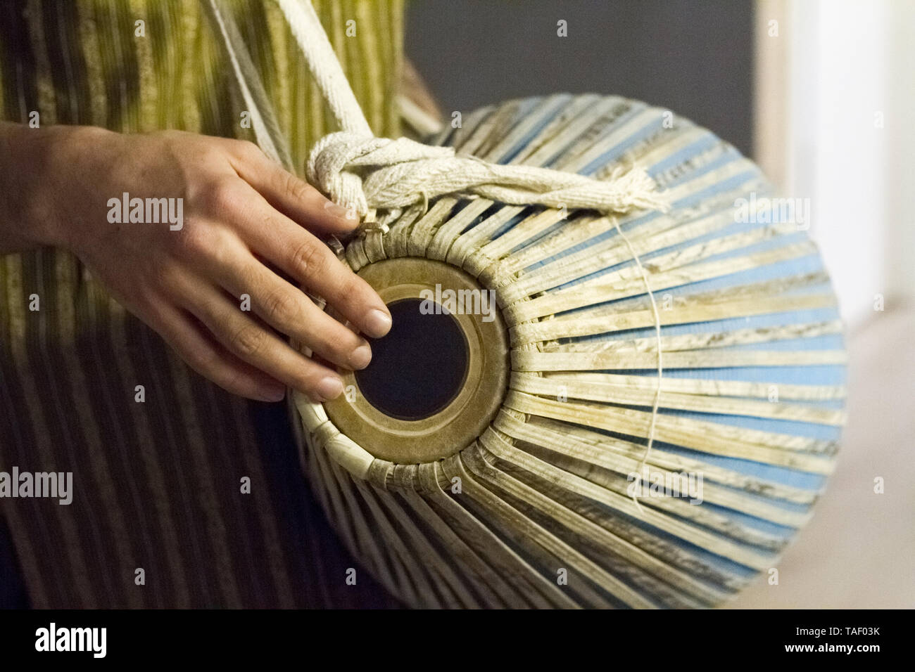Closeup of hands on indian drum, musical accompaniment in yoga studio, selective focus Stock Photo