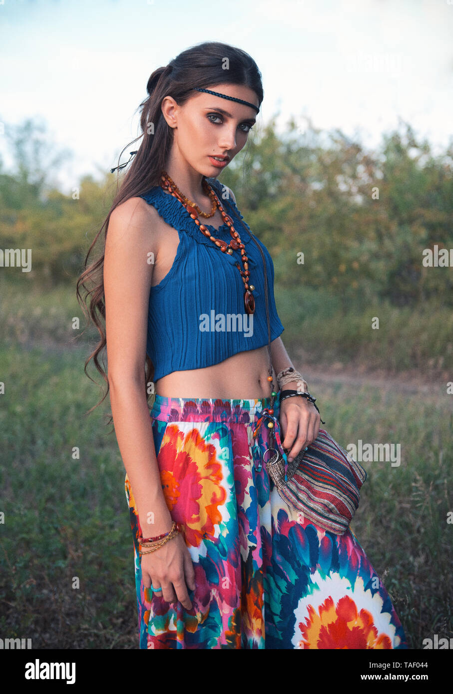 Outdoor portrait of the charming young boho (hippie) girl in