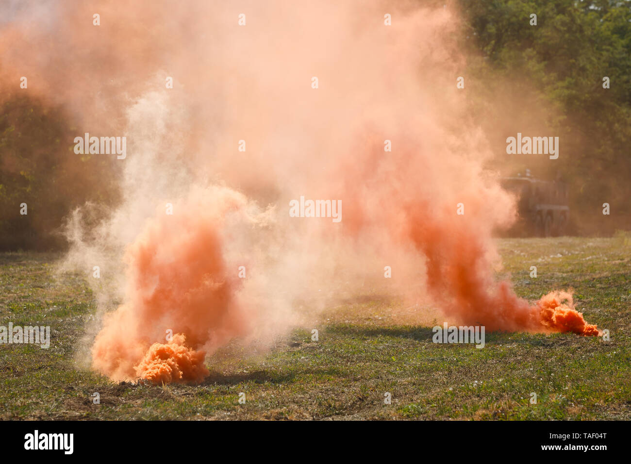 Two orange smoke grenades on the battlefield Stock Photo Alamy