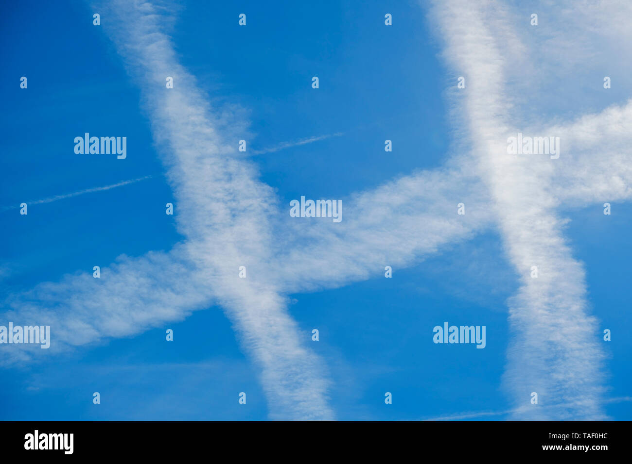 Germany, Bavaria, vapour trails of airplanes in the sky Stock Photo