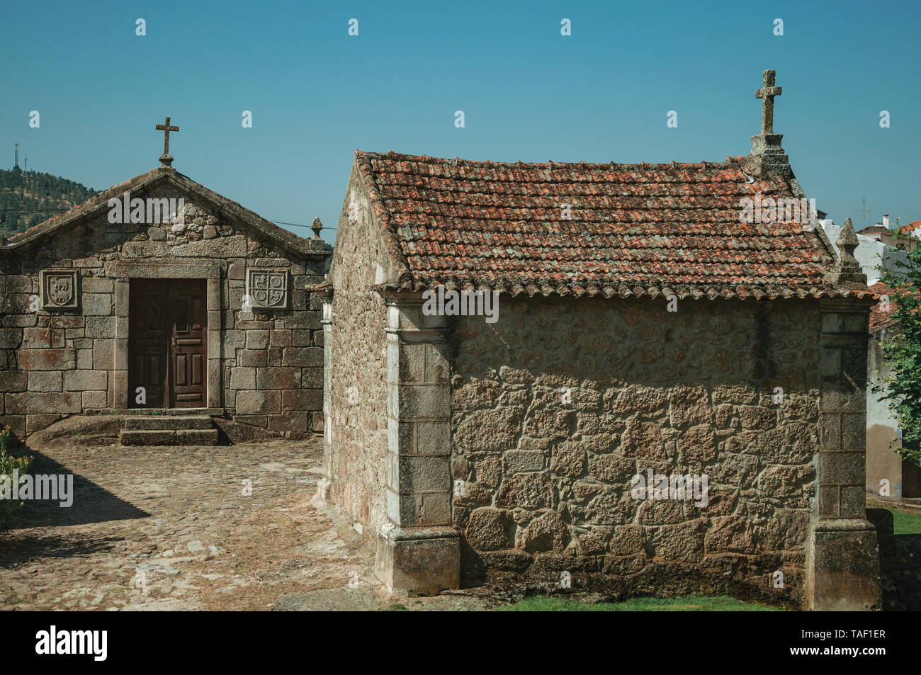 Medieval chapels of Saint Anthony and Calvary on a cobblestone square at Belmonte. Birthplace of the discoverer Pedro Cabral in Portugal. Stock Photo