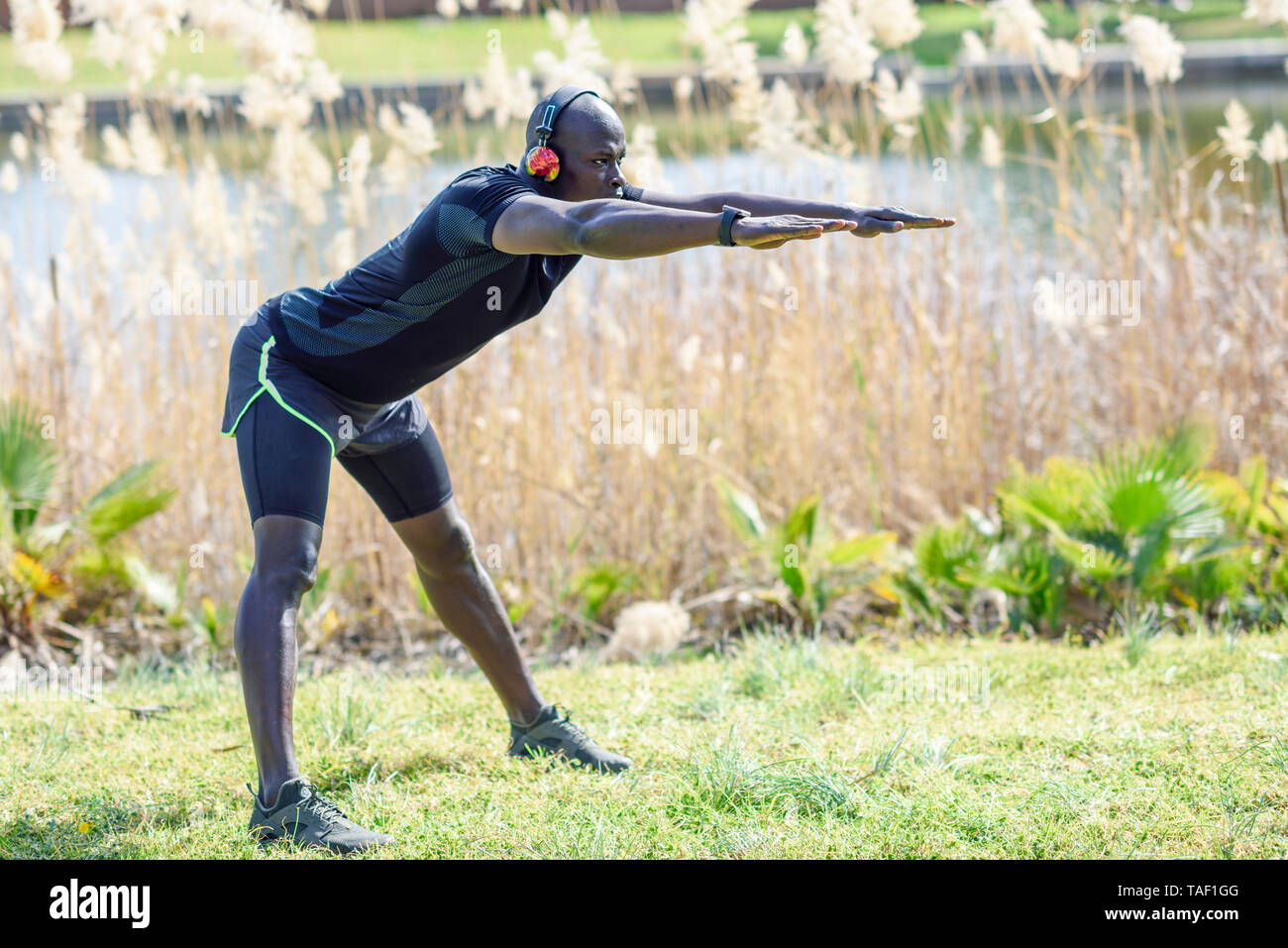 Men doing stretching exercises in park hi res stock photography and images Alamy