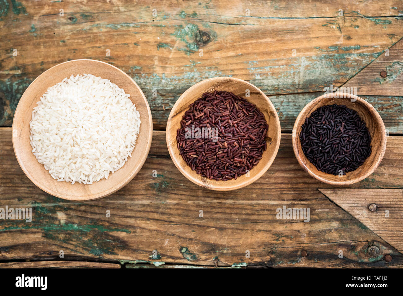 RIce, red rice, black rice in bowls, from above Stock Photo Alamy