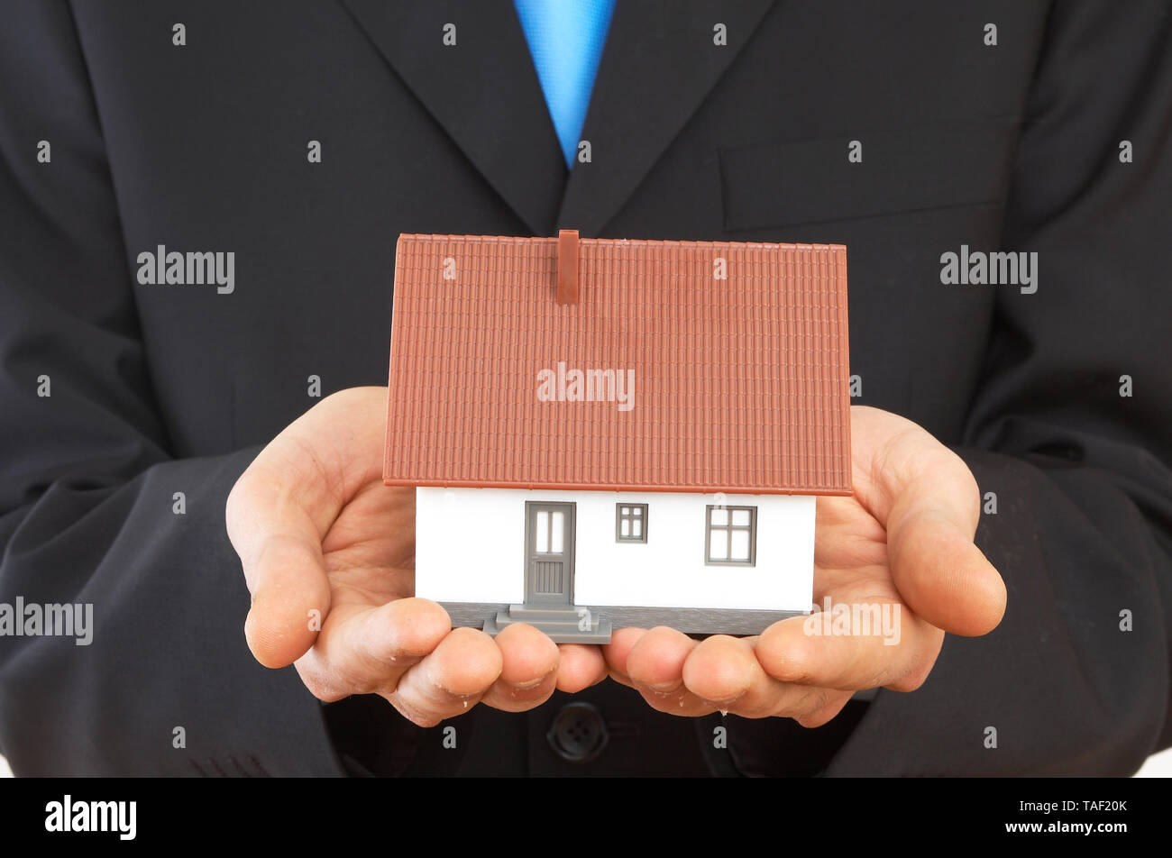 real estate concept with a mini house Stock Photo - Alamy