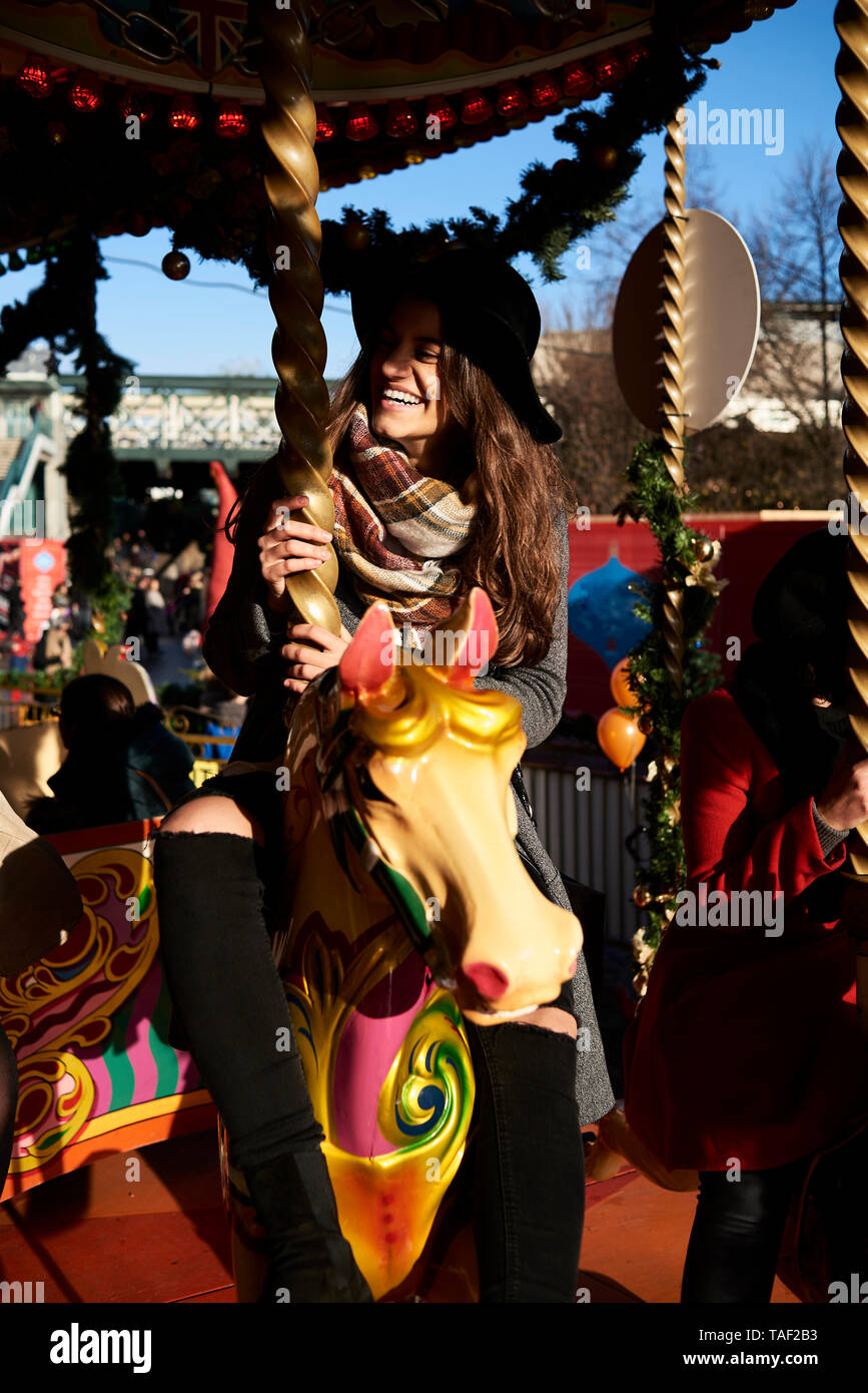 Happy woman having fun on a carousel Stock Photo