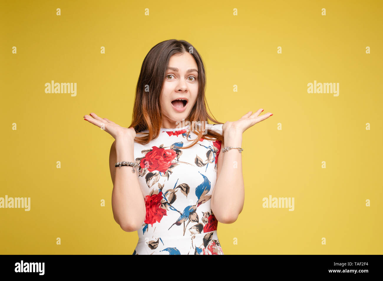 Surprised young girl on yellow isolated background in studio Stock ...