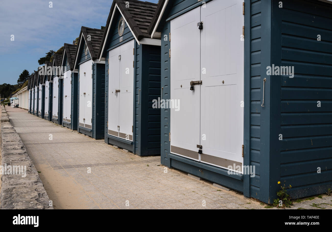 New blue and white Beach huts on Bournemouth beach between Alum Chine and Branksome Chine Stock Photo