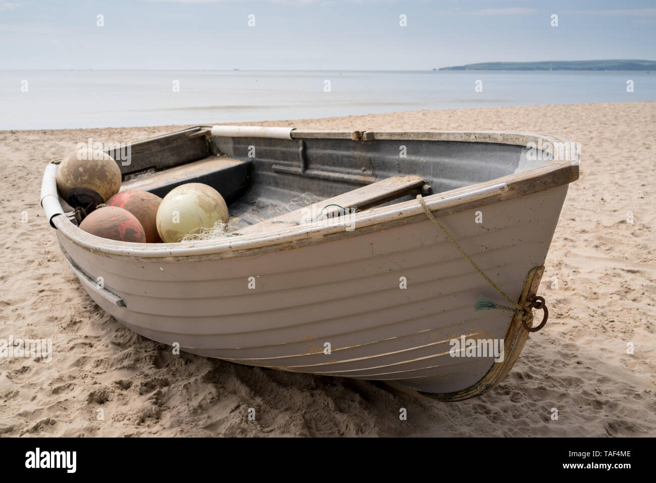 Old fishing boat on Bournemouth beach near Branksome Chine with the sea and Studland in the distance Stock Photo