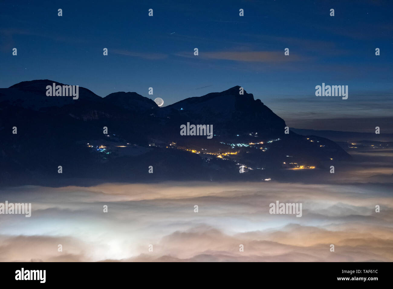 Stratus illuminated by the Arve Valley, cloud sea and moon, at night