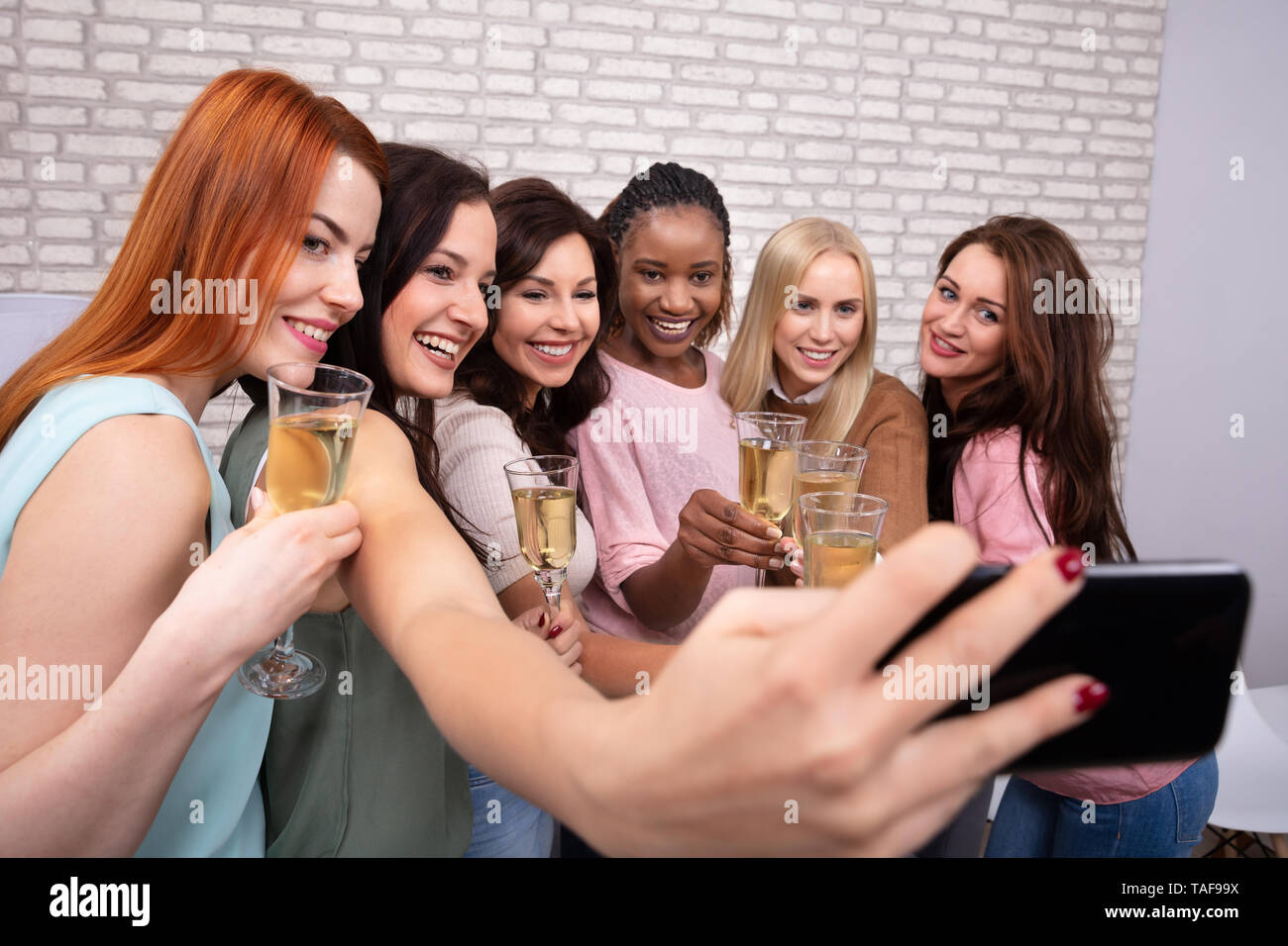 Happy Women With Champagne And Smartphone Taking Selfie At Night Club Stock Photo