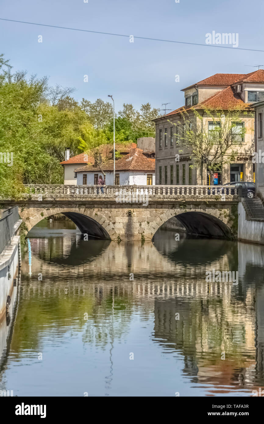 Viseu / Portugal - 04 16 2019 : View of the downtown area of Viseu with Pavia river and banks with buildings, trees and vegetation in Portugal Stock Photo