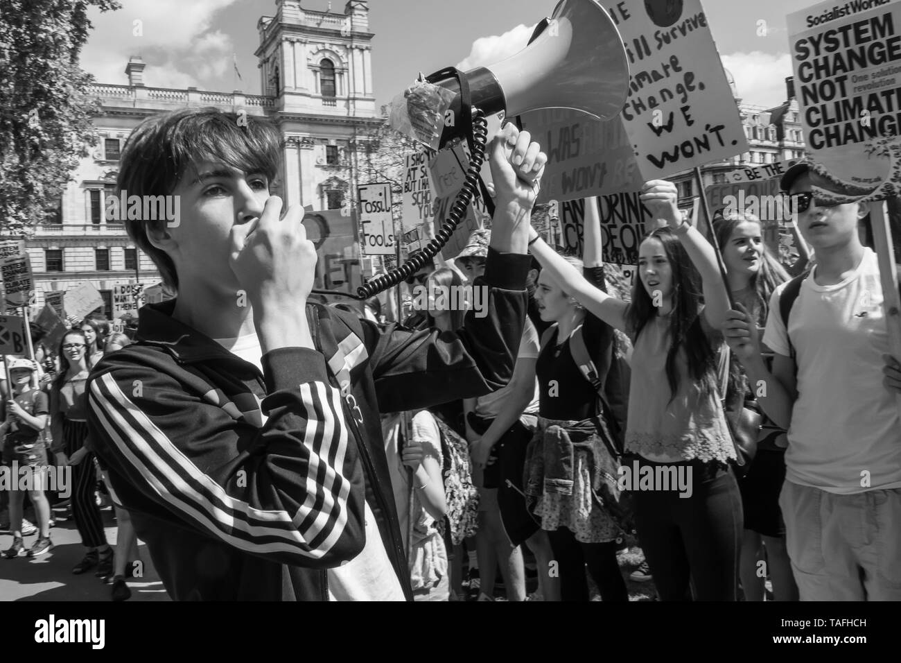 London, UK. 24th May 2019. Students protest in London and over 100 locations in the UK in the global climate strike against lack of action by governments worldwide to combat the climate crisis. They met in Parliament Square  where they held a short rallly before marching past several ministries to sit down at the Dept for Education, demanding curriculum change to teach about climate. Peter Marshall/Alamy Live News Stock Photo