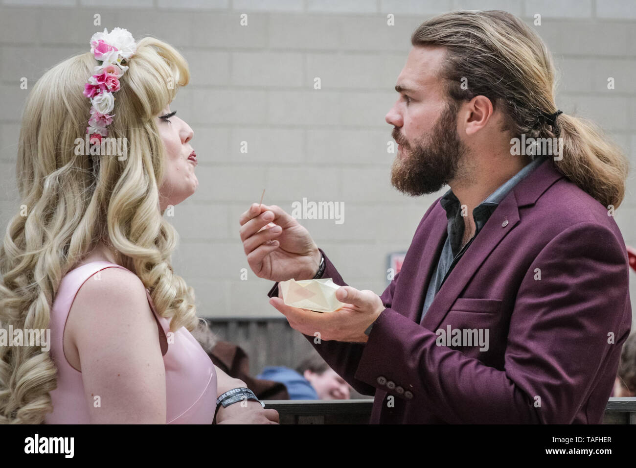 ExCel London, UK - 24th May 2019. Even a princess needs some food once in a while. Thousands of cosplayers, gamers and lovers of film and TV fantasy and sci fi in costumes come together on the opening day of MCM Comicon at ExCel London. Credit: Imageplotter/Alamy Live News Stock Photo