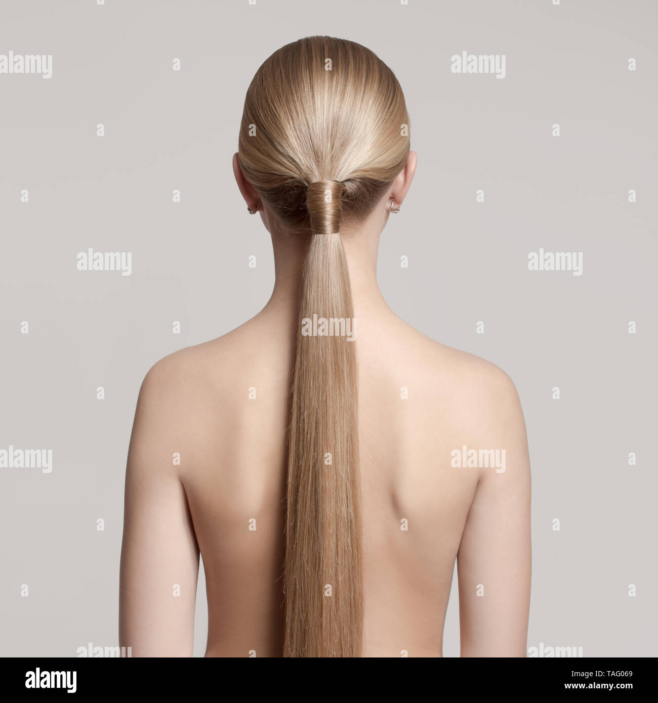 Woman With A Hair Tail Back View Gray Background Light