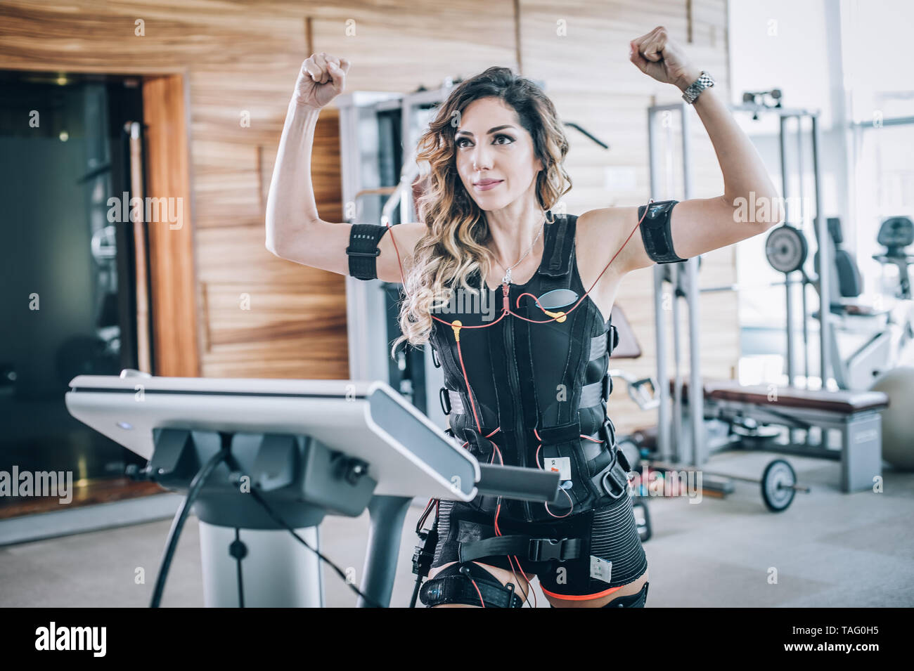 EMS electro stimulation women exercises with coach in modern gym. Electric muscle  stimulation workout Stock Photo - Alamy