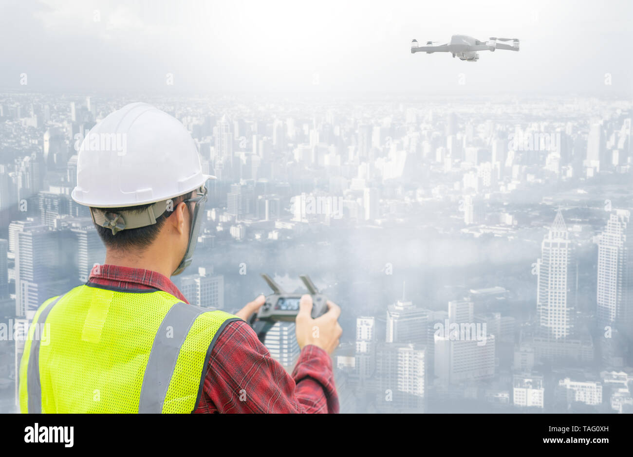Drone operated by construction worker on building site Stock Photo
