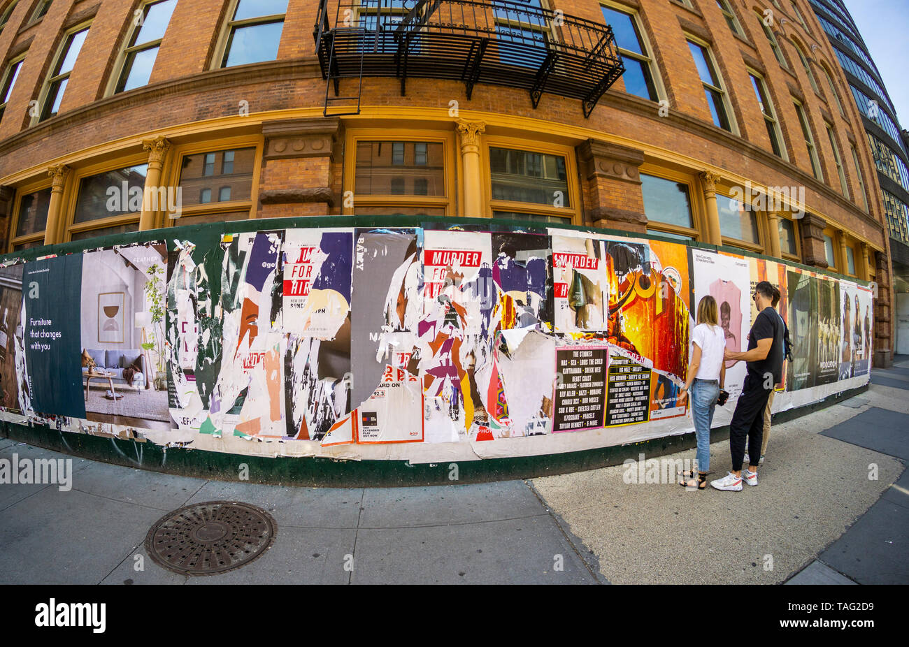 Construction shed covered with torn posters in New York on Saturday, May 18, 2019. (Â© Richard B. Levine) Stock Photo