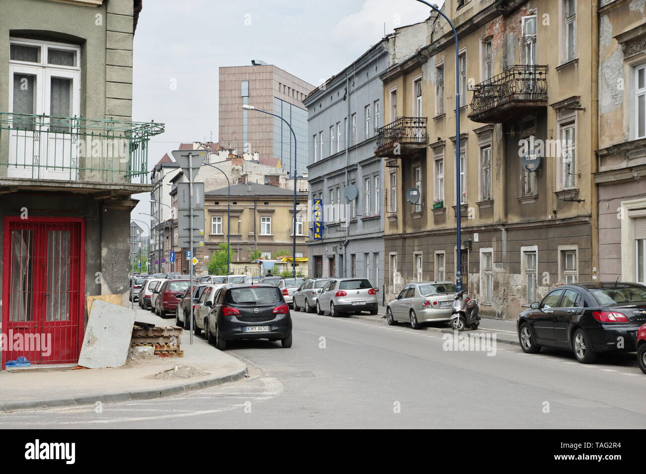 Krakow, Poland – May 12, 2019: district of Podgórze, Lwowska street. You can see old tenement houses and cars parked along the road. Stock Photo