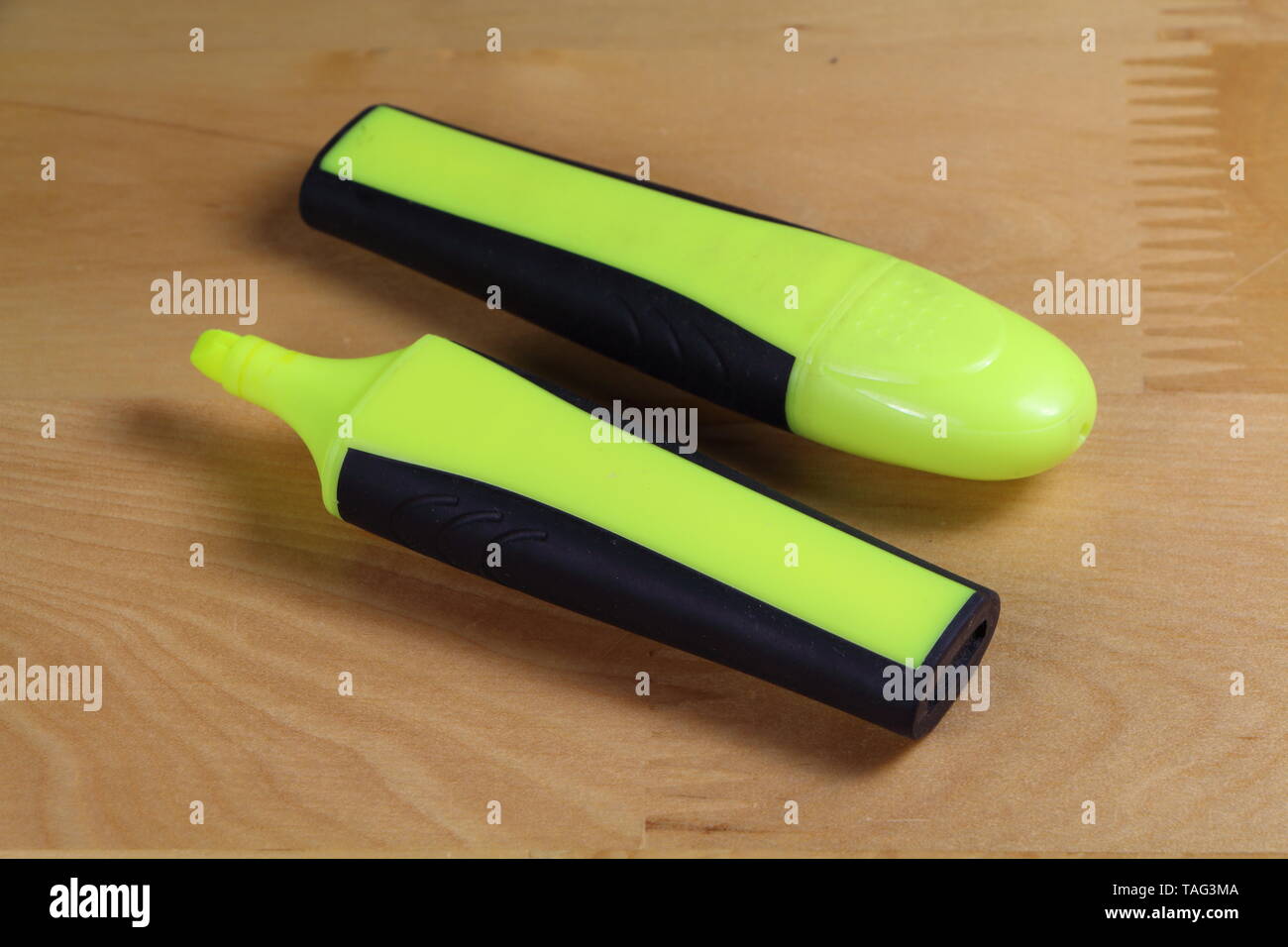 Two yellow highlighters, one with its cap and the other not Stock Photo