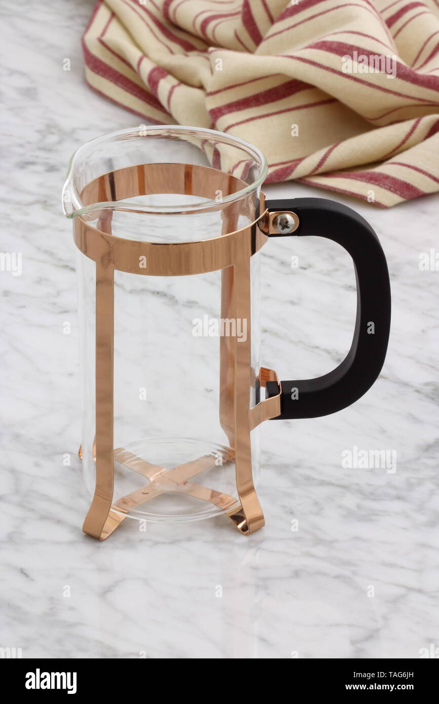 trendy and beautiful copper french press styled on carrara marble table