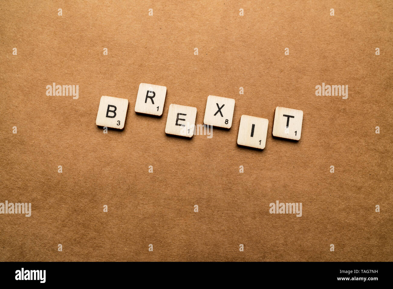 LONDON, UK - May 24 2019: The word BREXIT, spelt with wooden letter tiles over a brown textured background Stock Photo