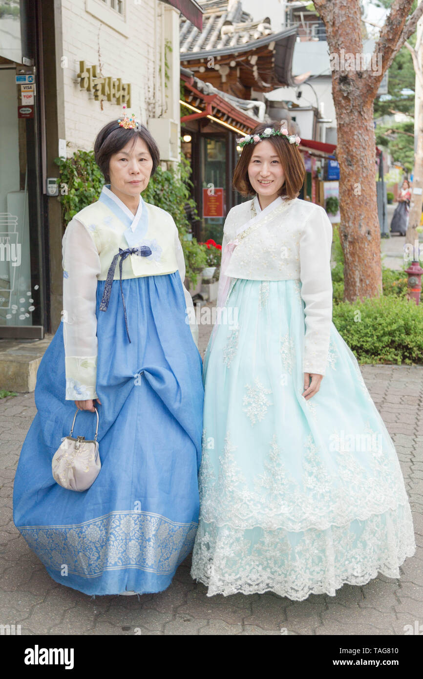 In Bukchon Hanok Village in Seoul, two Japanese tourists wearing the traditional Korean outfit 'Handbook' is a popular way to discover the area. Stock Photo