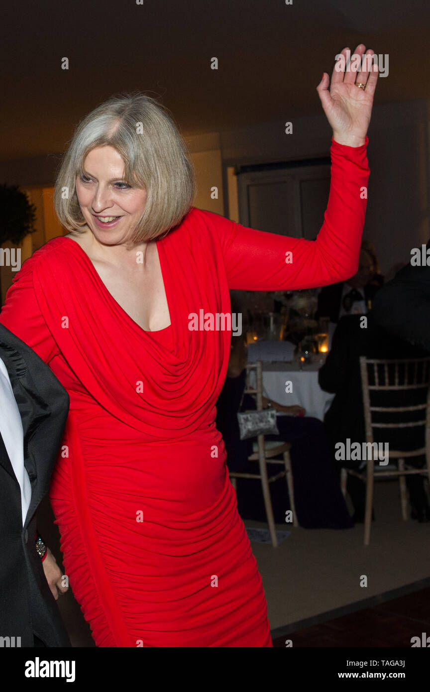 Coworth Park, Ascot, Berkshire, UK. 4th May, 2012. Maidenhead MP Theresa May and her husband Philip May attend the Mayor of the Royal Borough of Windsor and Maidenhead’s Charity Ball at Coworth Park in Ascot. Coworth Park is part of the Dorchester Collection. Theresa May joins in with the dancing. Credit: Maureen McLean/Alamy Stock Photo
