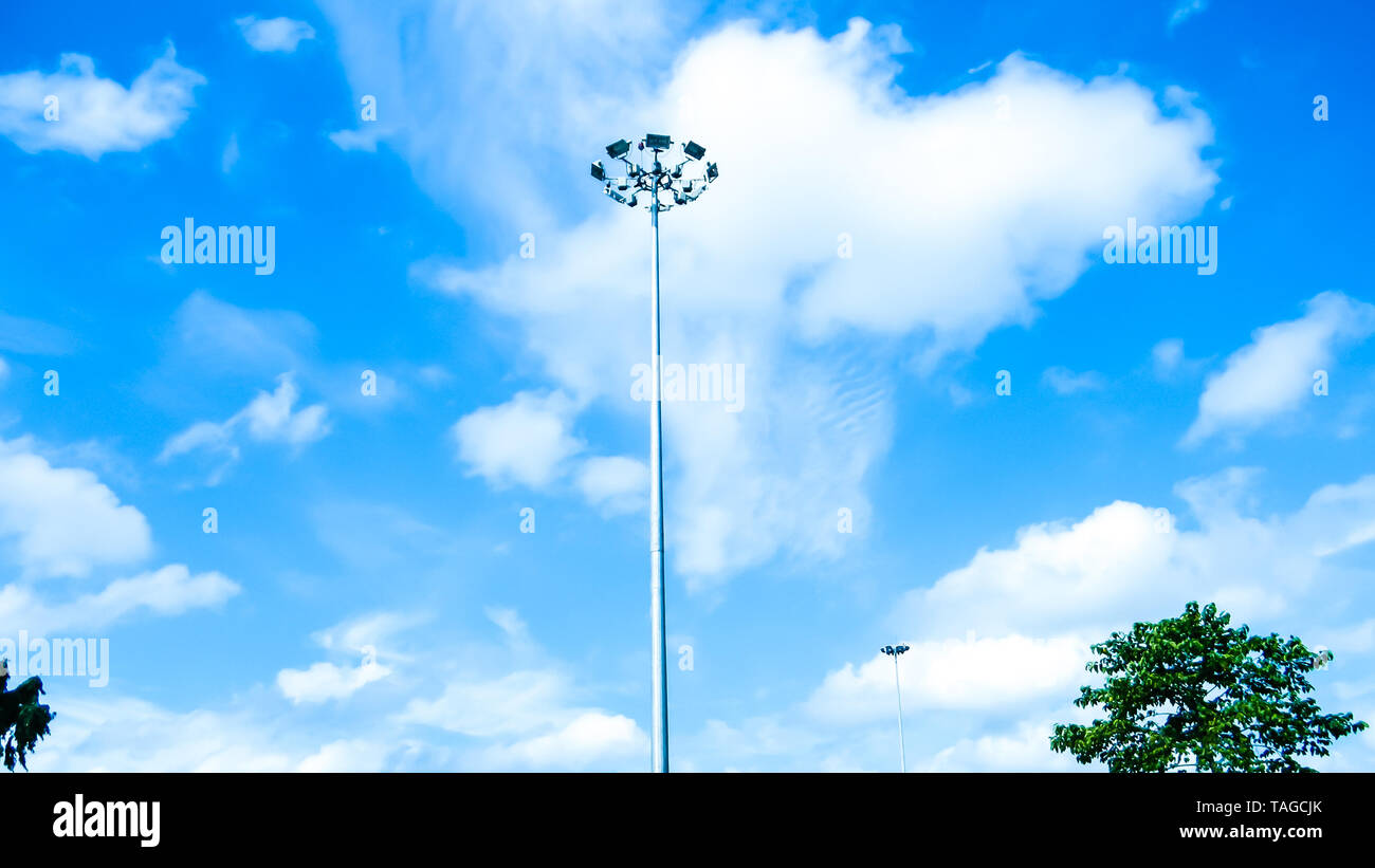 Street Public lighting pole against a blue sky and cloud background. Stock Photo