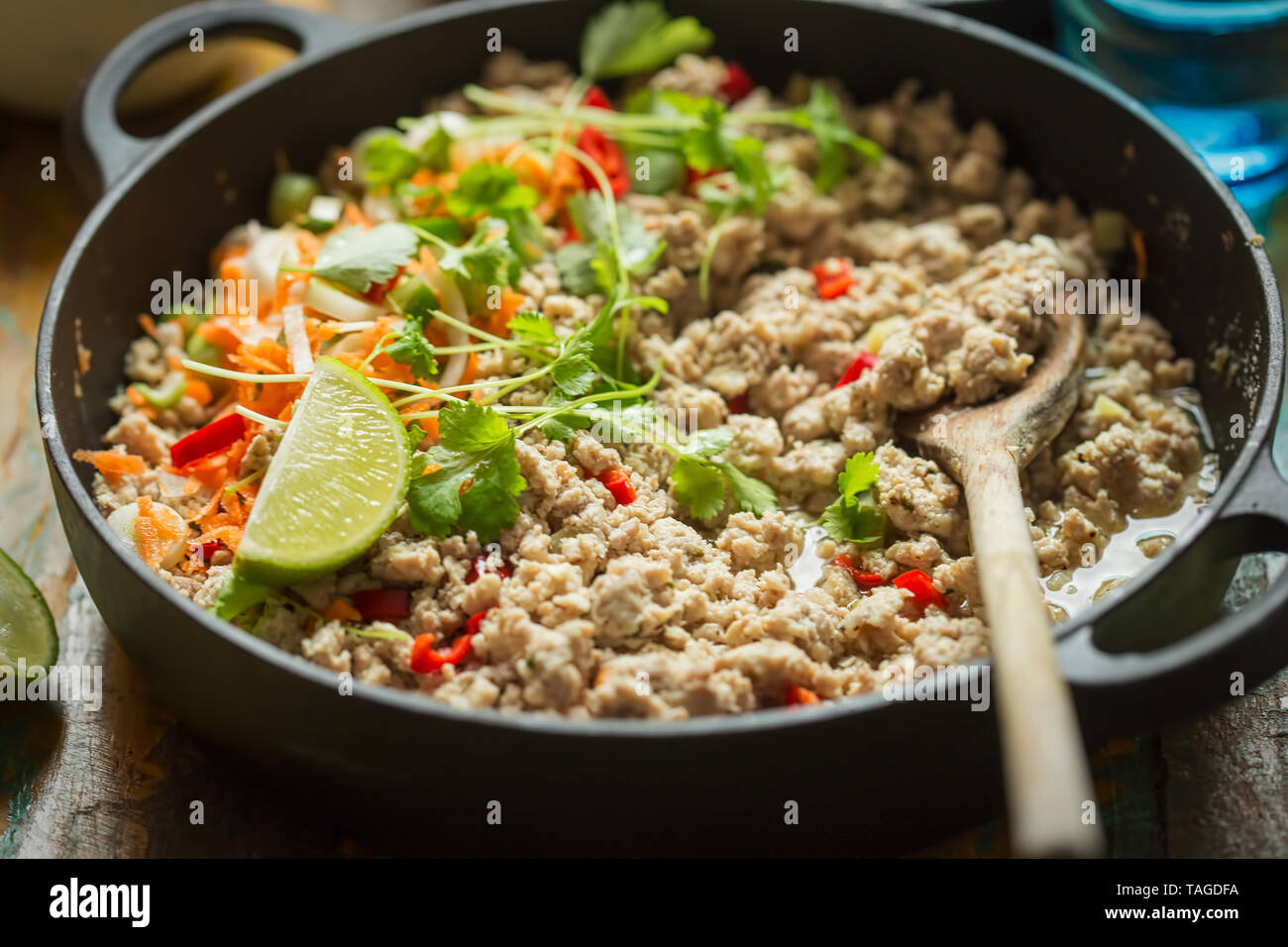 Chicken & pork larb with carrot, scallions and coriander Stock Photo
