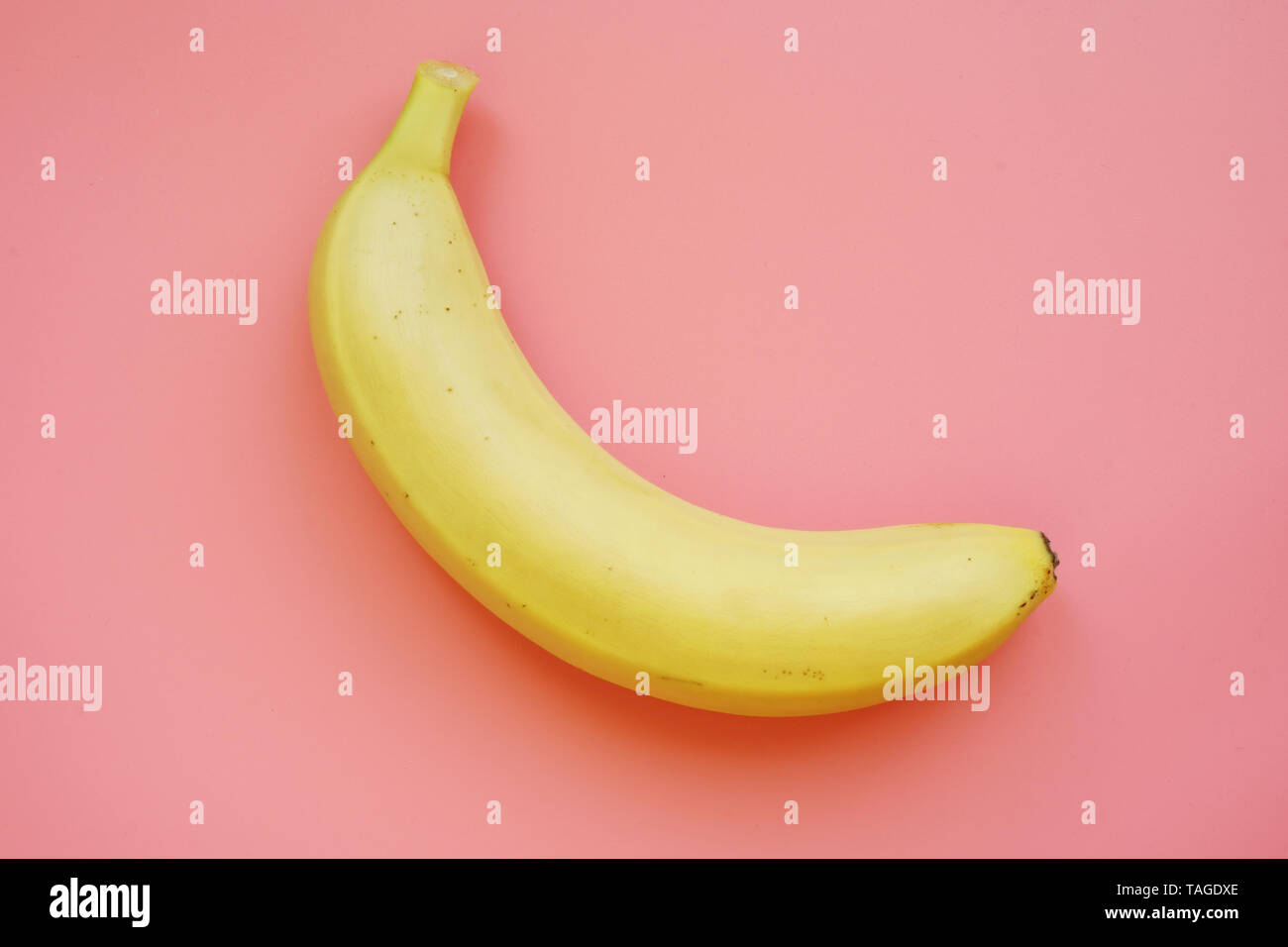 Banana on a pink background. Colorful fruit pattern. Stock Photo