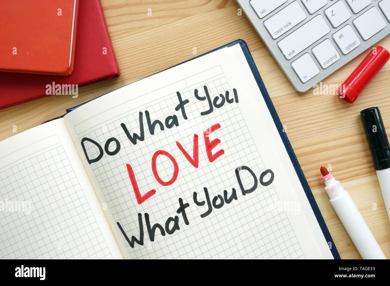 Do what you love what you do handwritten in a note. Stock Photo