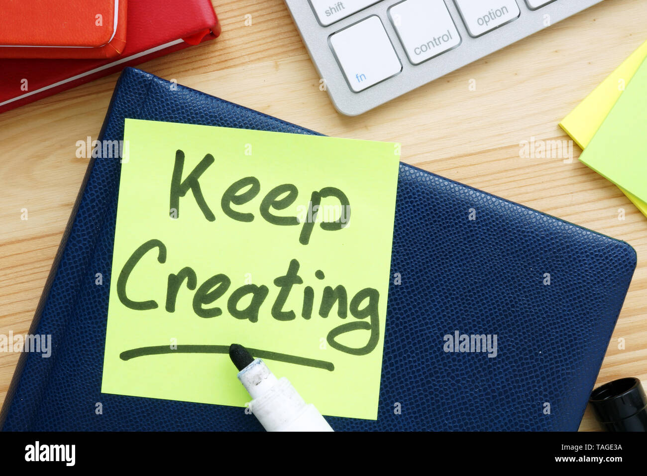 Keep creating handwritten on a memo. Inspiration quote. Stock Photo