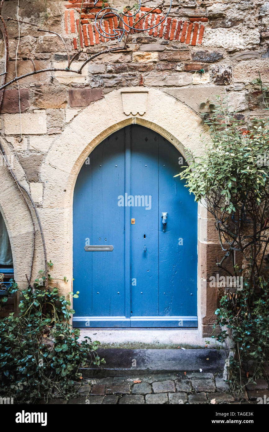 Beautiful old blue door and a pointed stone arch Stock Photo
