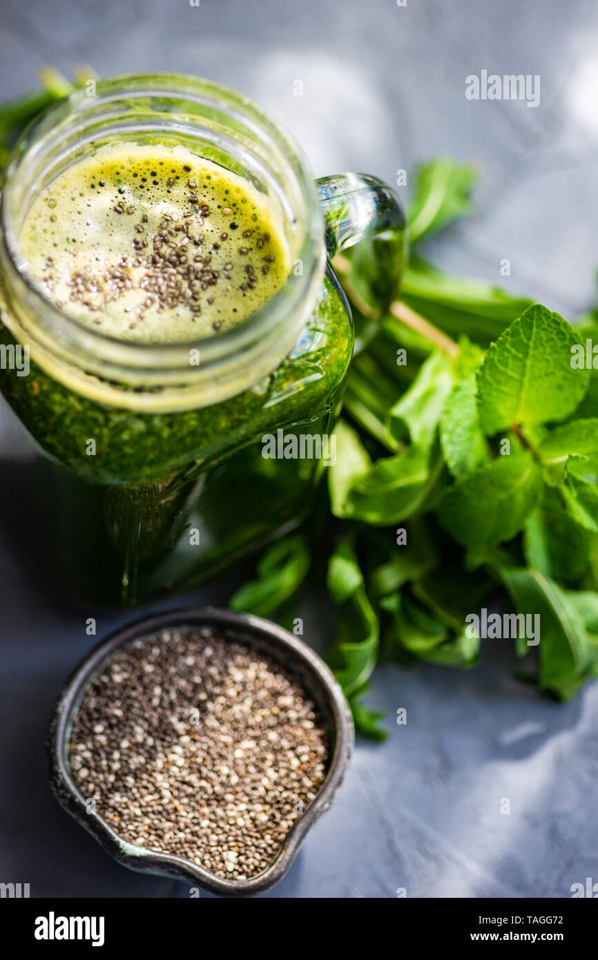 Organic vegetable smoothie with spinach and chia seeds on rustic