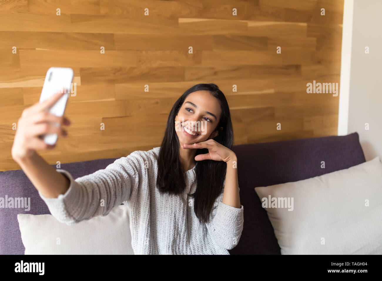 Portrait Of A Beautiful Brunette Taking A Selfie With Her Smart Phone