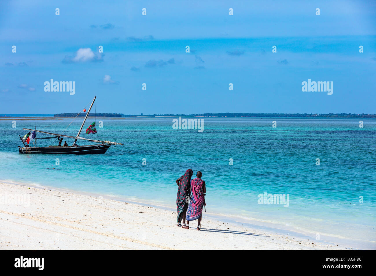Kendwa, Zanzibar-March 4, 2019 : Masai people looking at boat on Kendwa beach Stock Photo