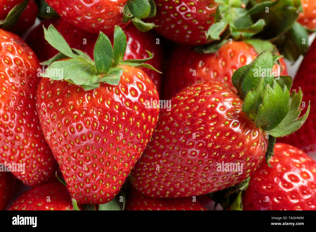 Pile of red strawberries close up background Stock Photo - Alamy