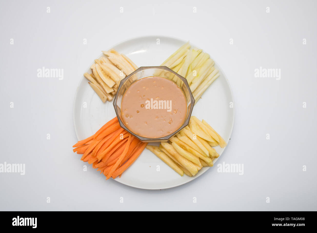 Fruits and Vegetables with peanut butter ready for snacking Stock Photo
