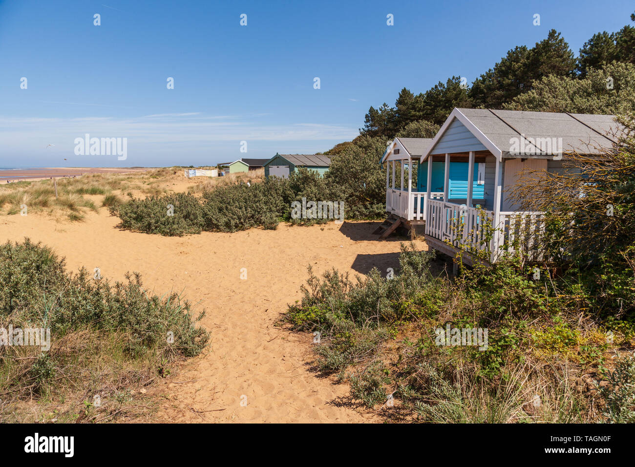 beach huts in the sand dunes at old hunstanton on the north norfolk coast Stock Photo